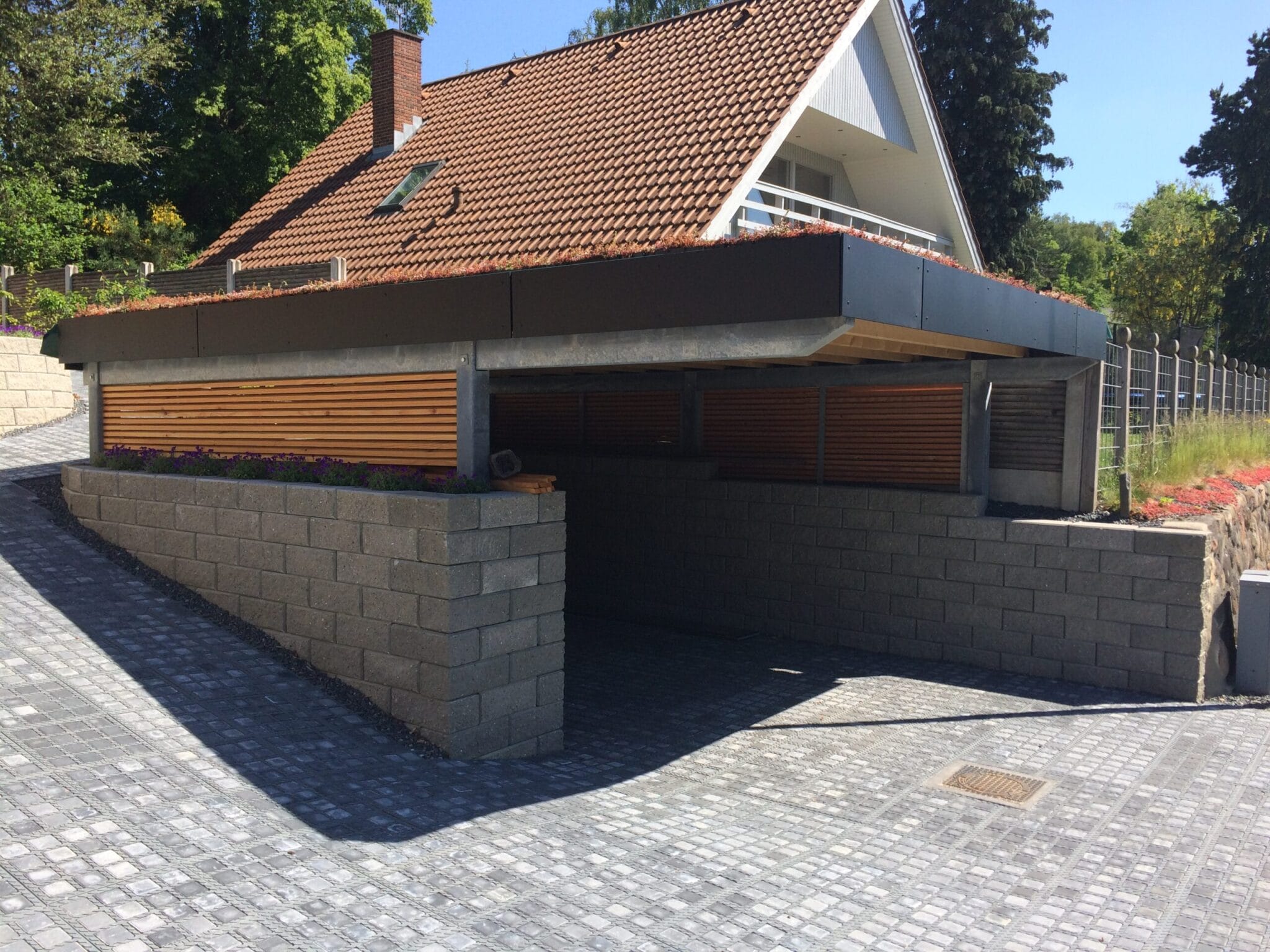 Moderne hus med carport og stenbelagt indkørsel